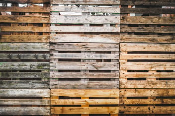 Image with different pallets of mixed ages and materials. 